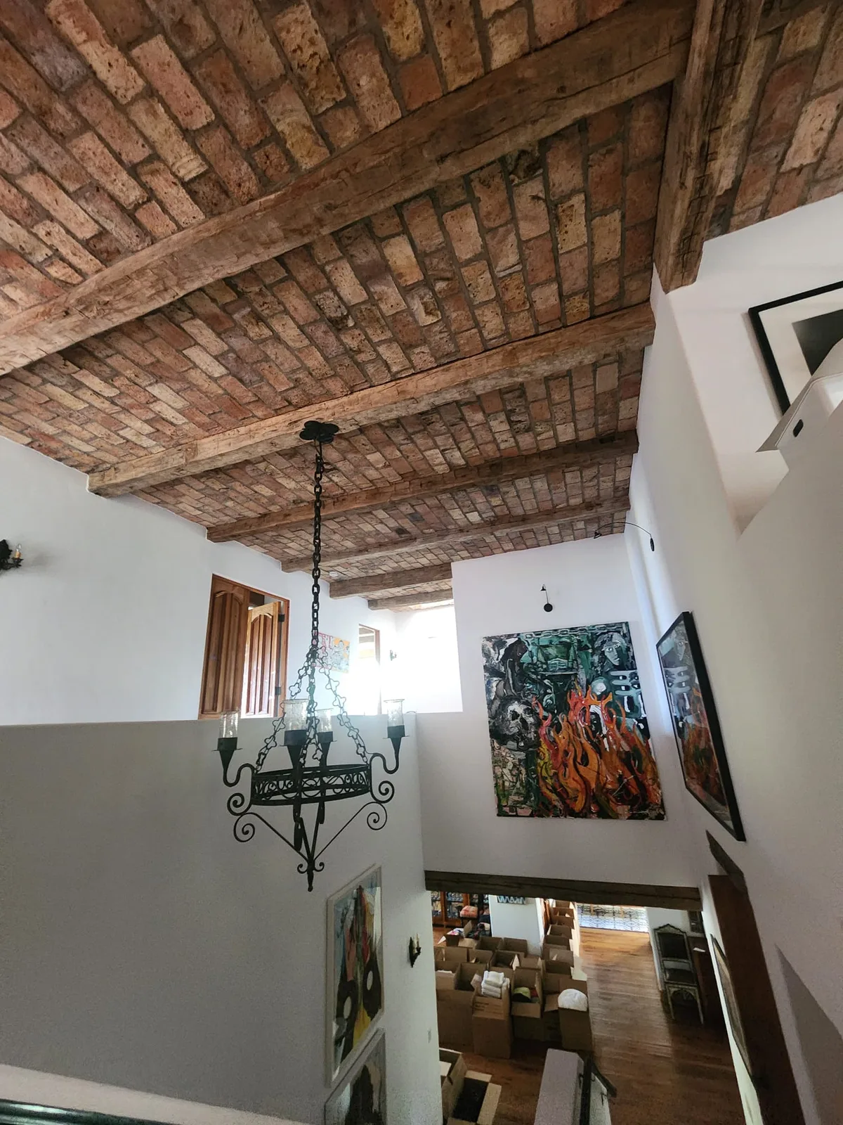 Aged brick and timber beam vaulted ceiling.