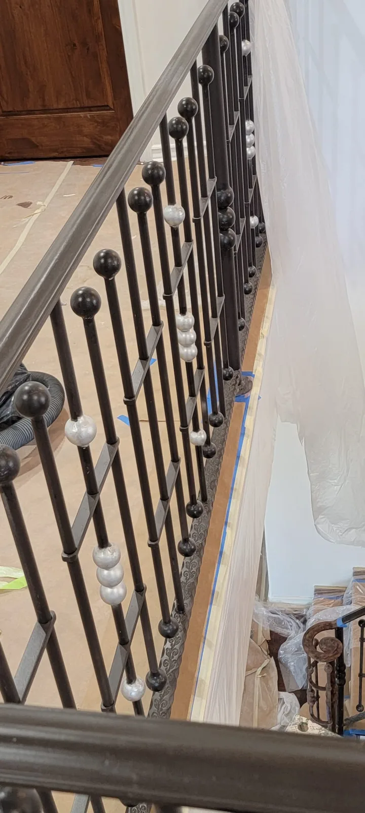 Close detail of a hand-refinished wrought iron stair railing.